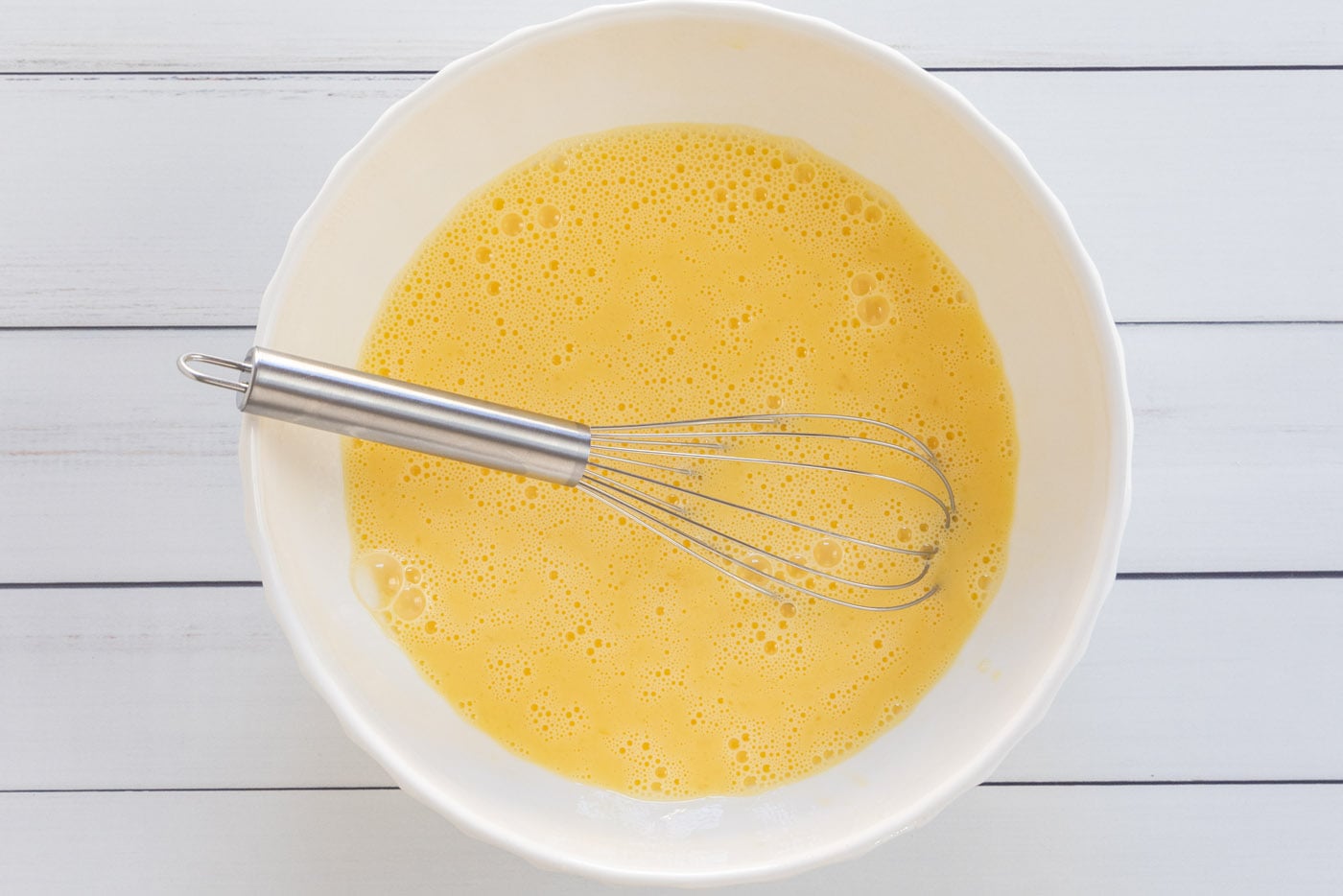 egg and milk mixture whisked in a bowl