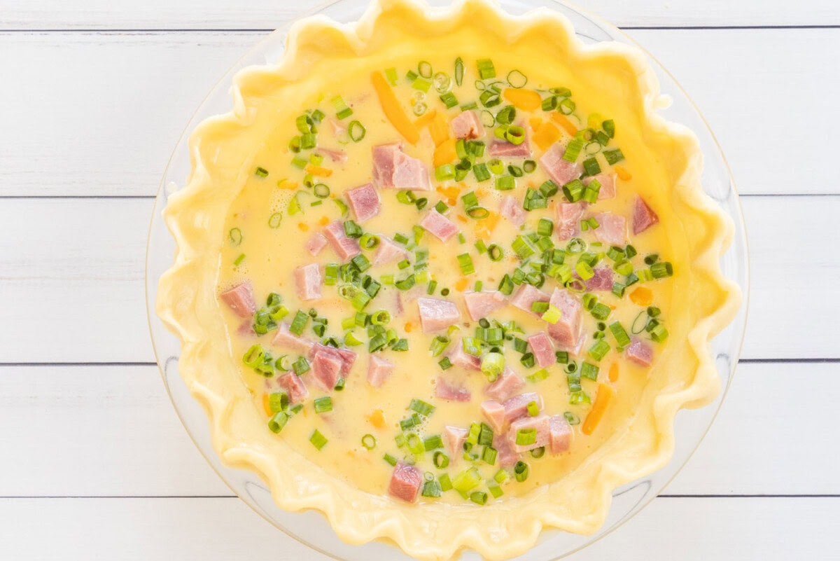green onions on top of quiche mixture