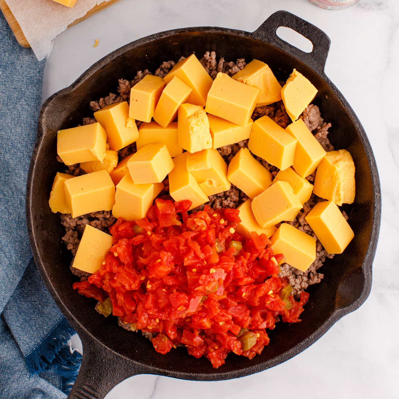 Rotel tomatoes, Velveeta cheese, and ground beef dip in a skillet