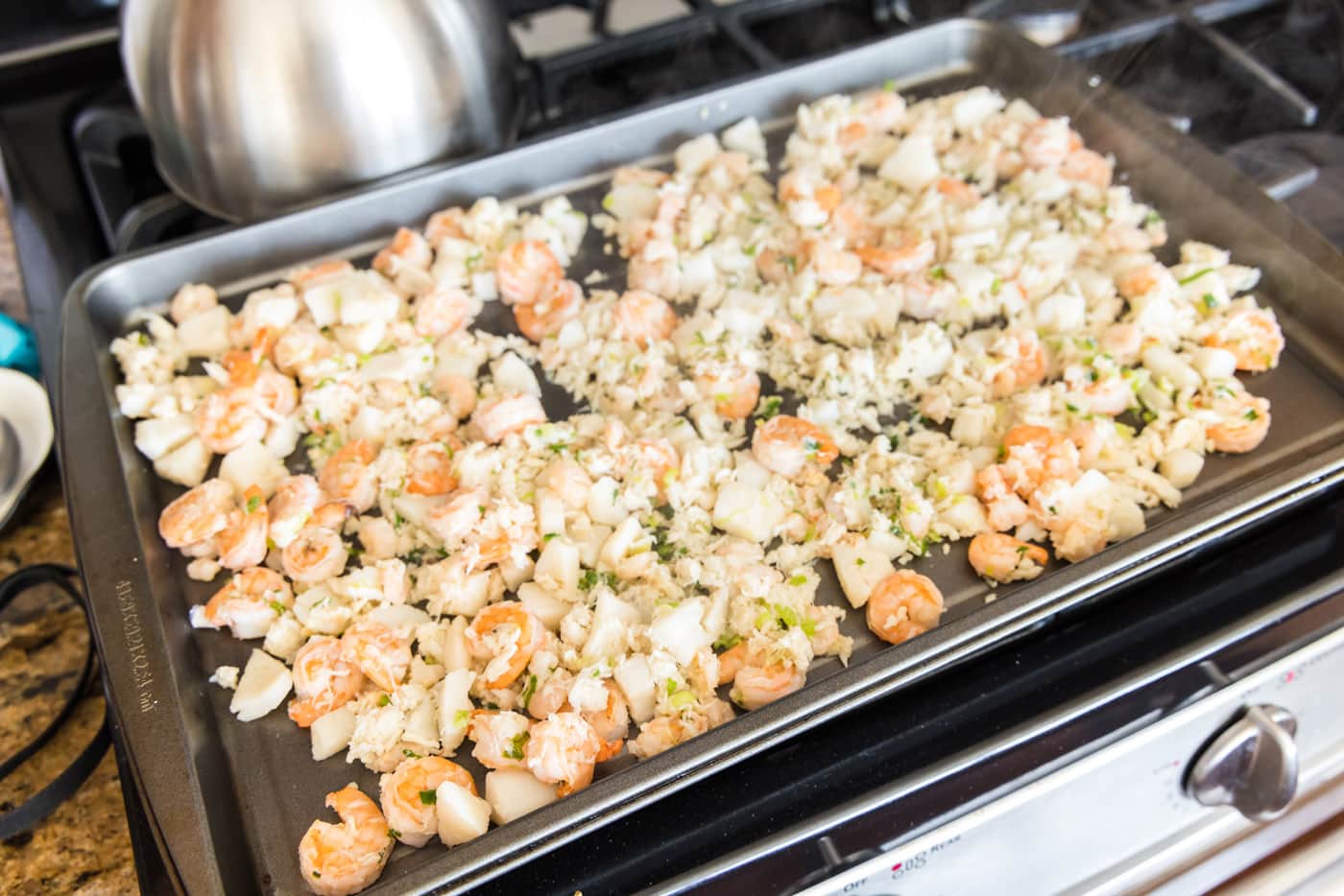 crab meat, scallops, and shrimp on a baking tray