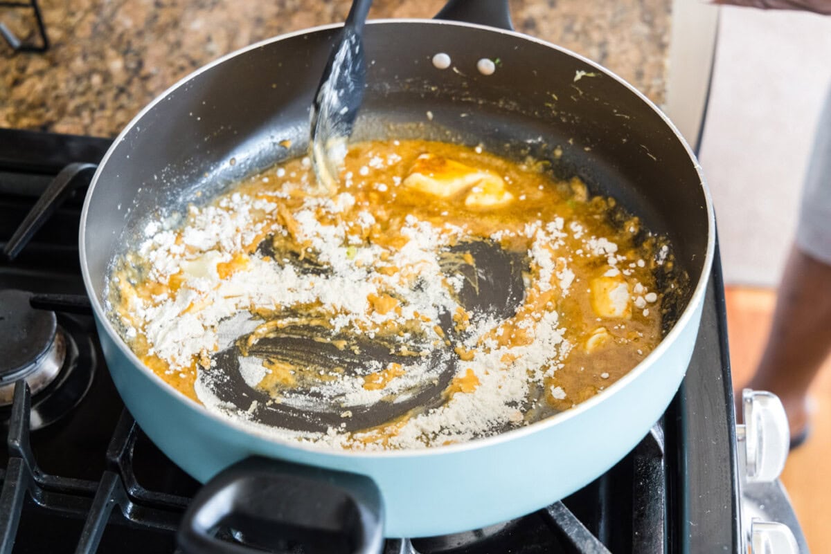 mixing flour to make a roux in a skillet