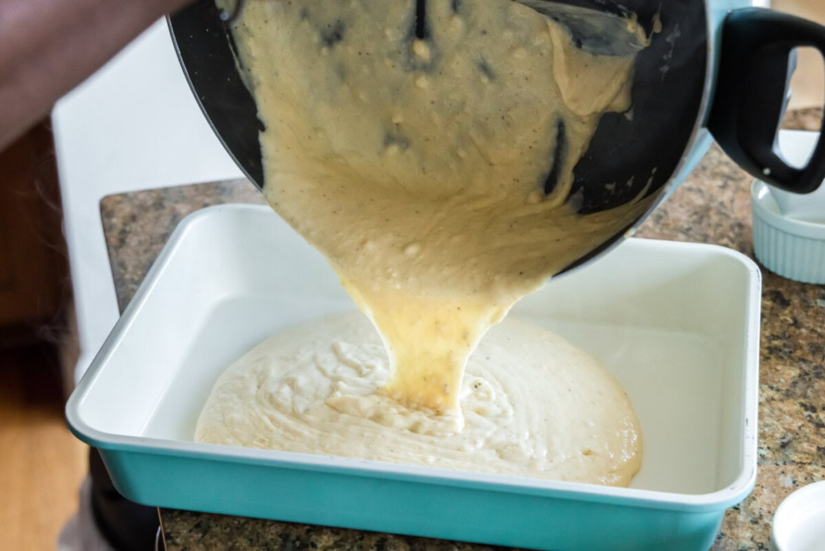 pouring seafood sauce into baking dish