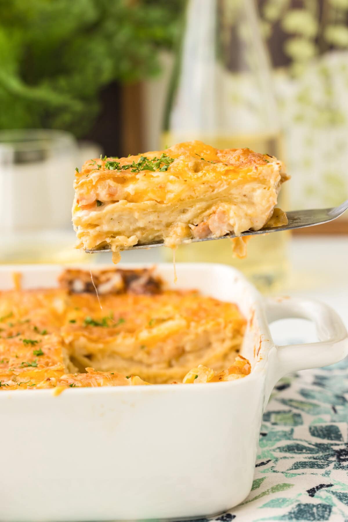 lifting a slice of Seafood Lasagna