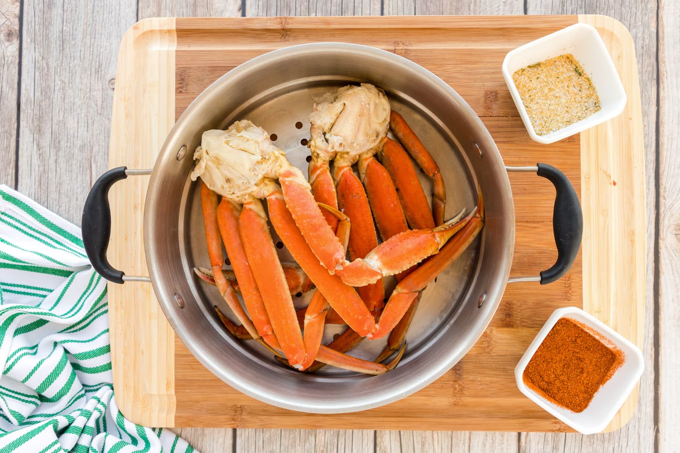 snow crab legs in steamer basket with water