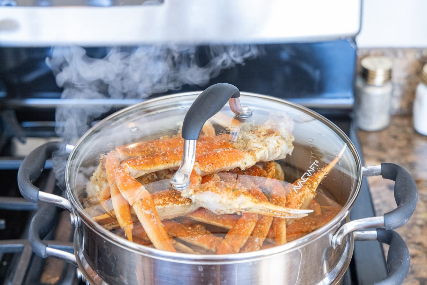 steam coming off of snow crab legs in steam pot