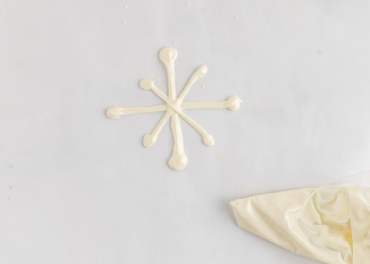 piping white chocolate snowflake