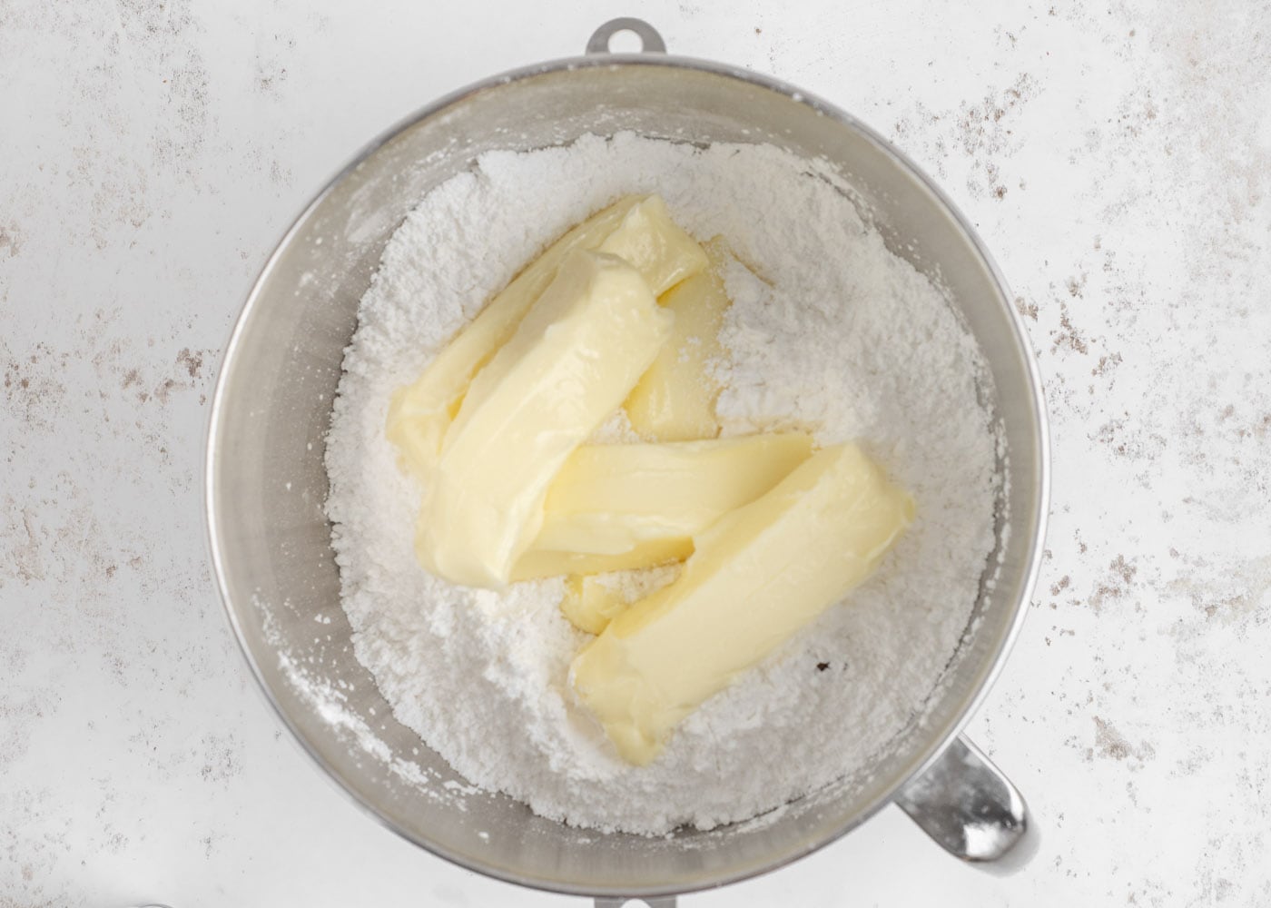 butter and powdered sugar in a bowl of a stand mixer