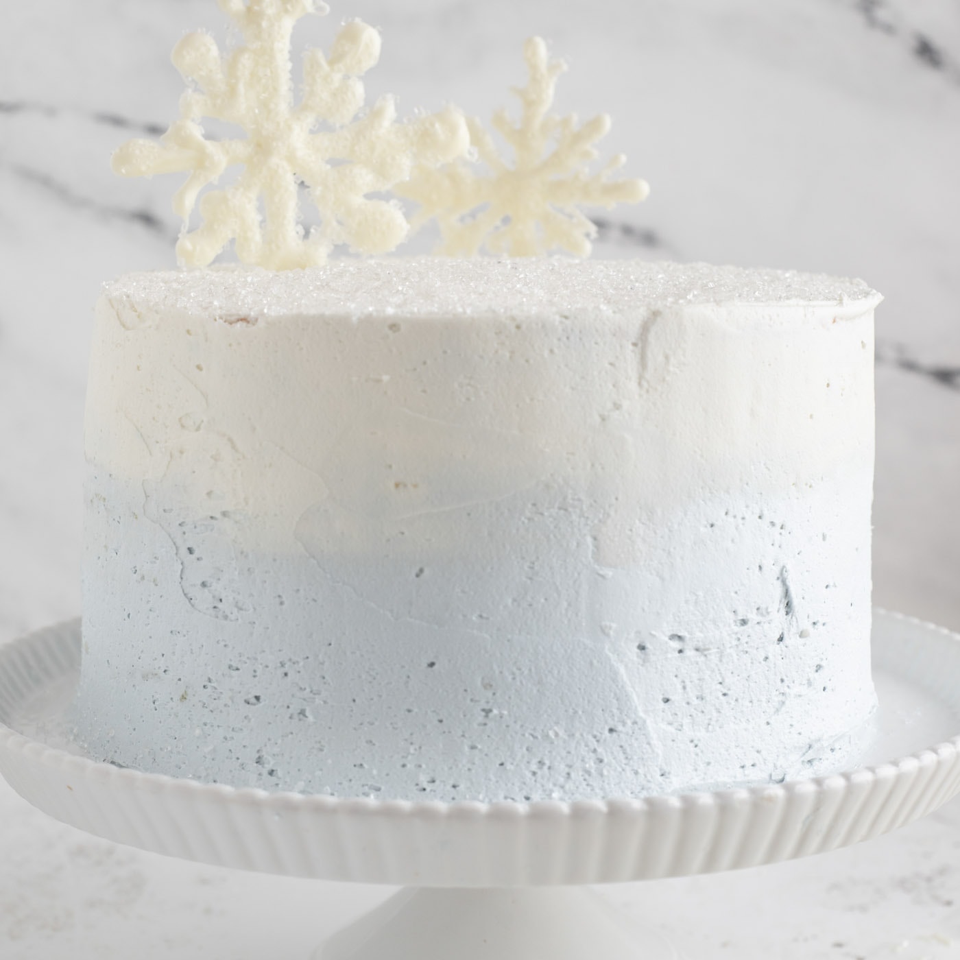 white chocolate snowflakes added to tiered cake