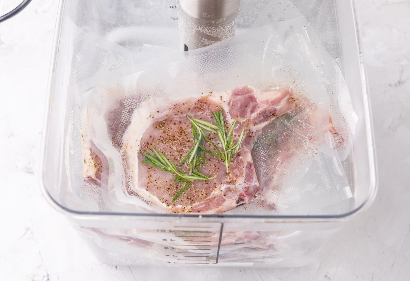 vacuum sealed pork chops in sous vid container