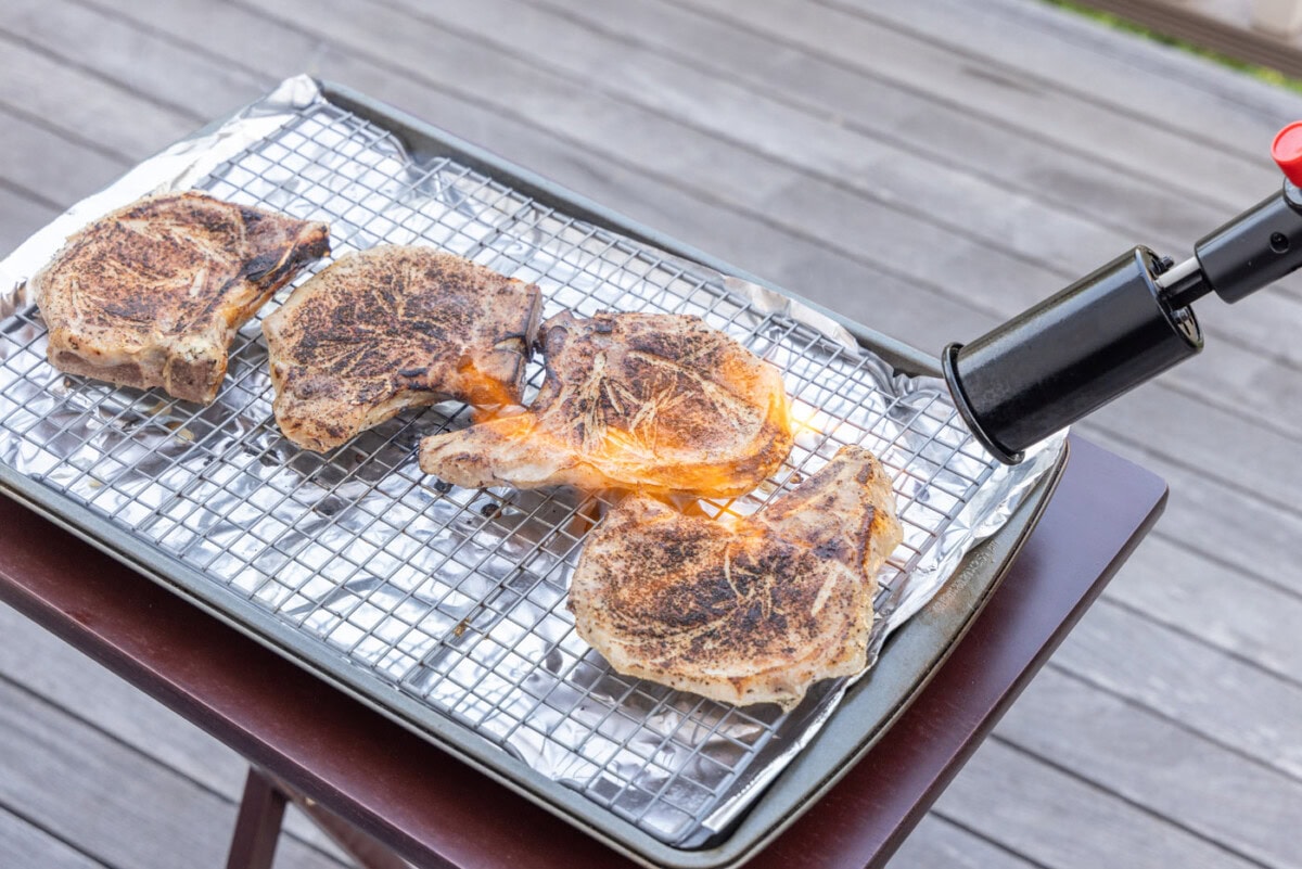 searing pork chops with a kitchen torch