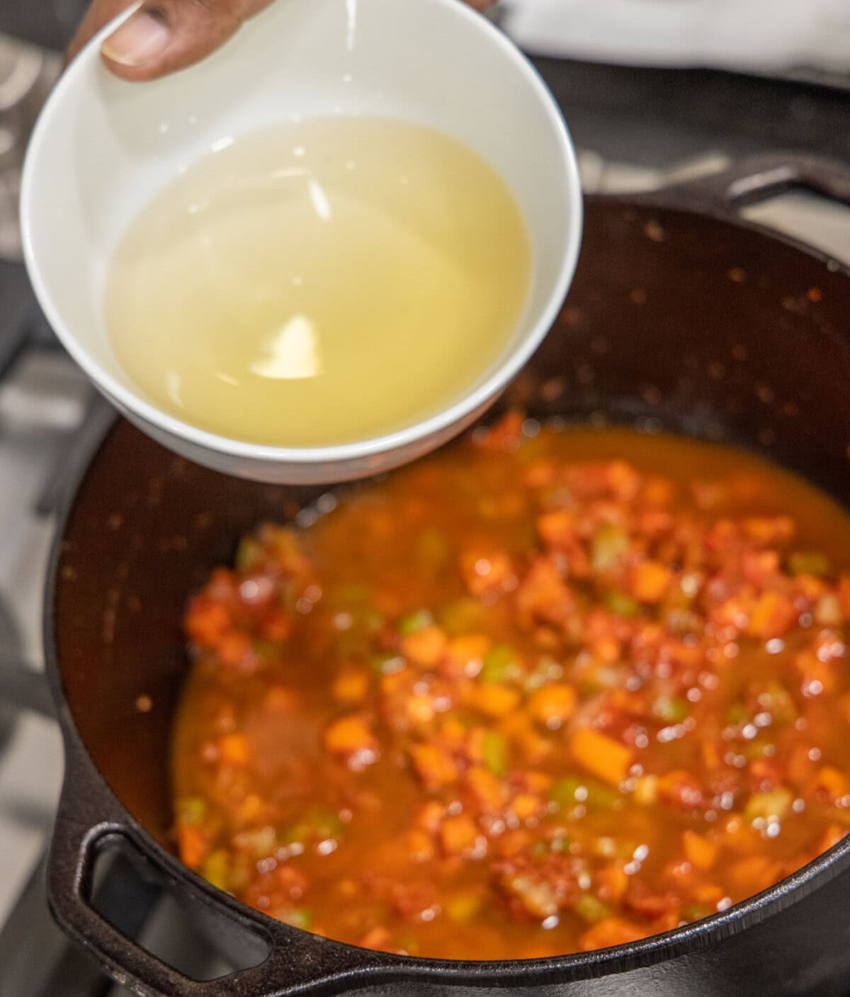 adding white wine to veal osso buco in dutch oven
