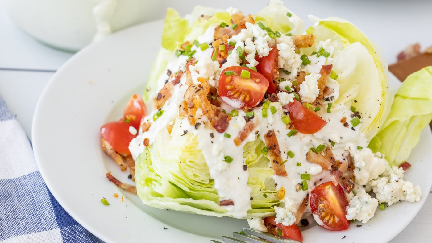 Topped with the necessary classics, this wedge salad is one you'll need to use a knife for, not just