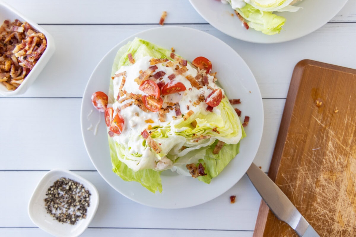 cherry tomatoes, bacon, and bleu cheese dressing on iceberg lettuce