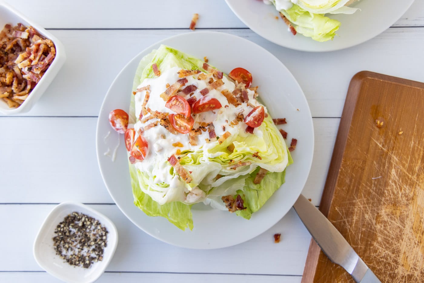 cherry tomatoes, bacon, and bleu cheese dressing on iceberg lettuce