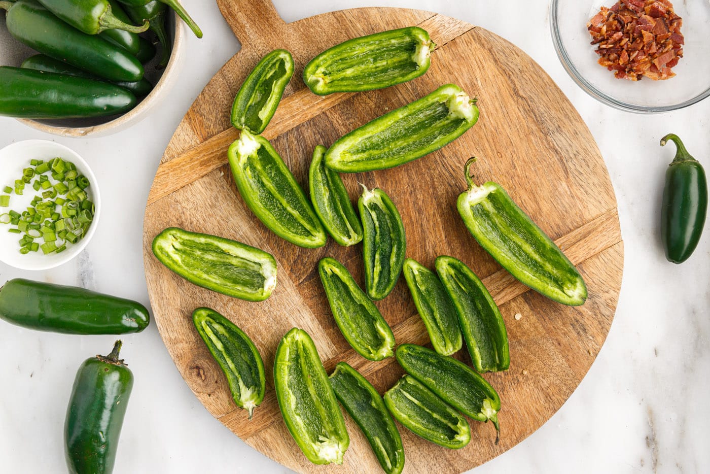 deseeded jalapeno peppers on a cutting board