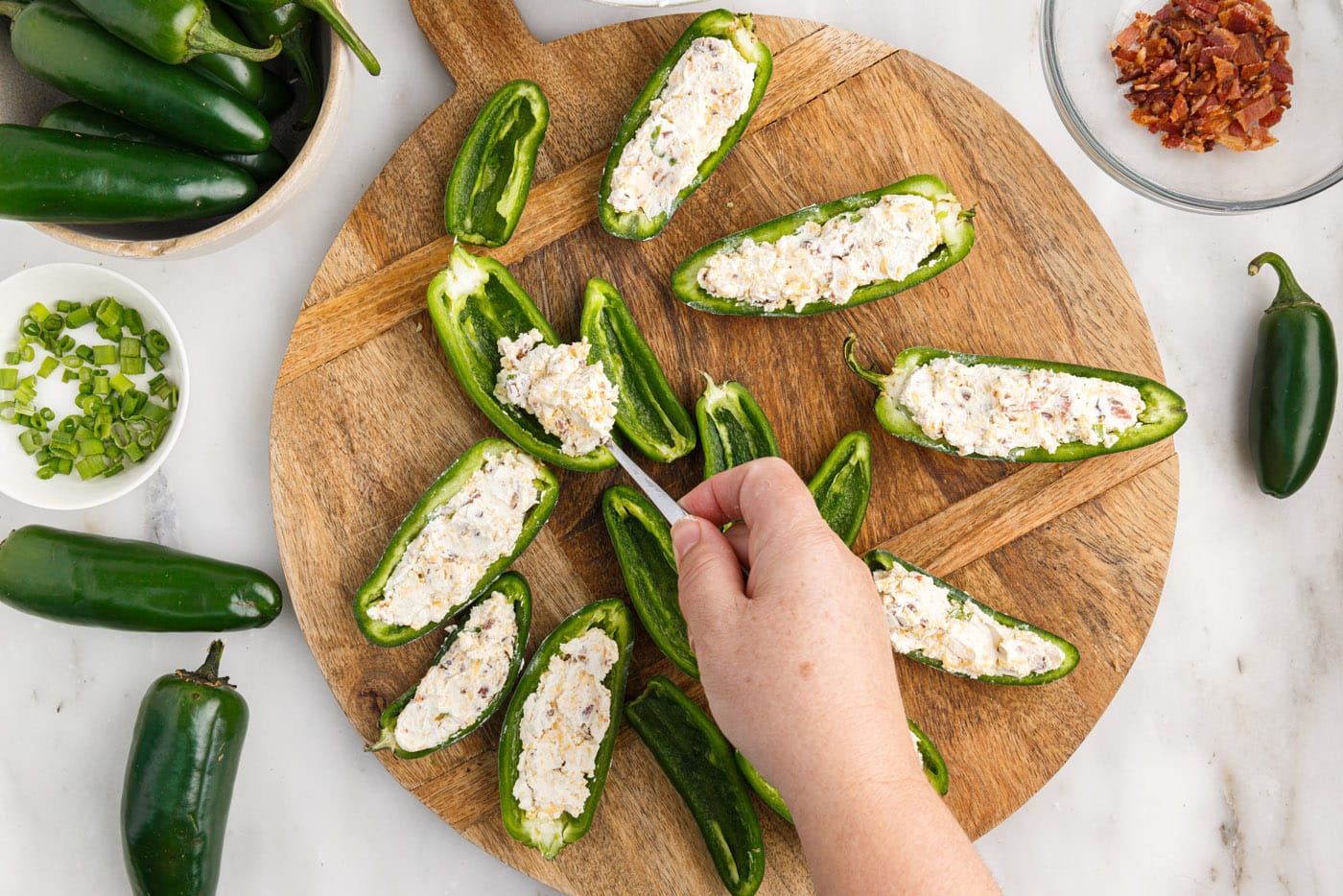 stuffing jalapeno pepper slices with cream cheese filling