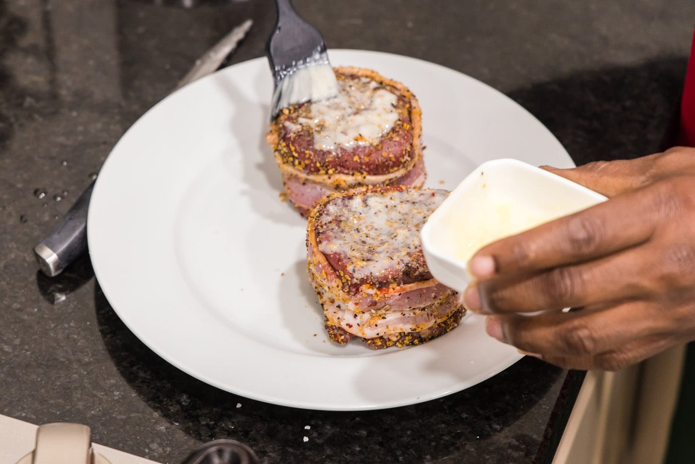 brushing filet mignon with butter