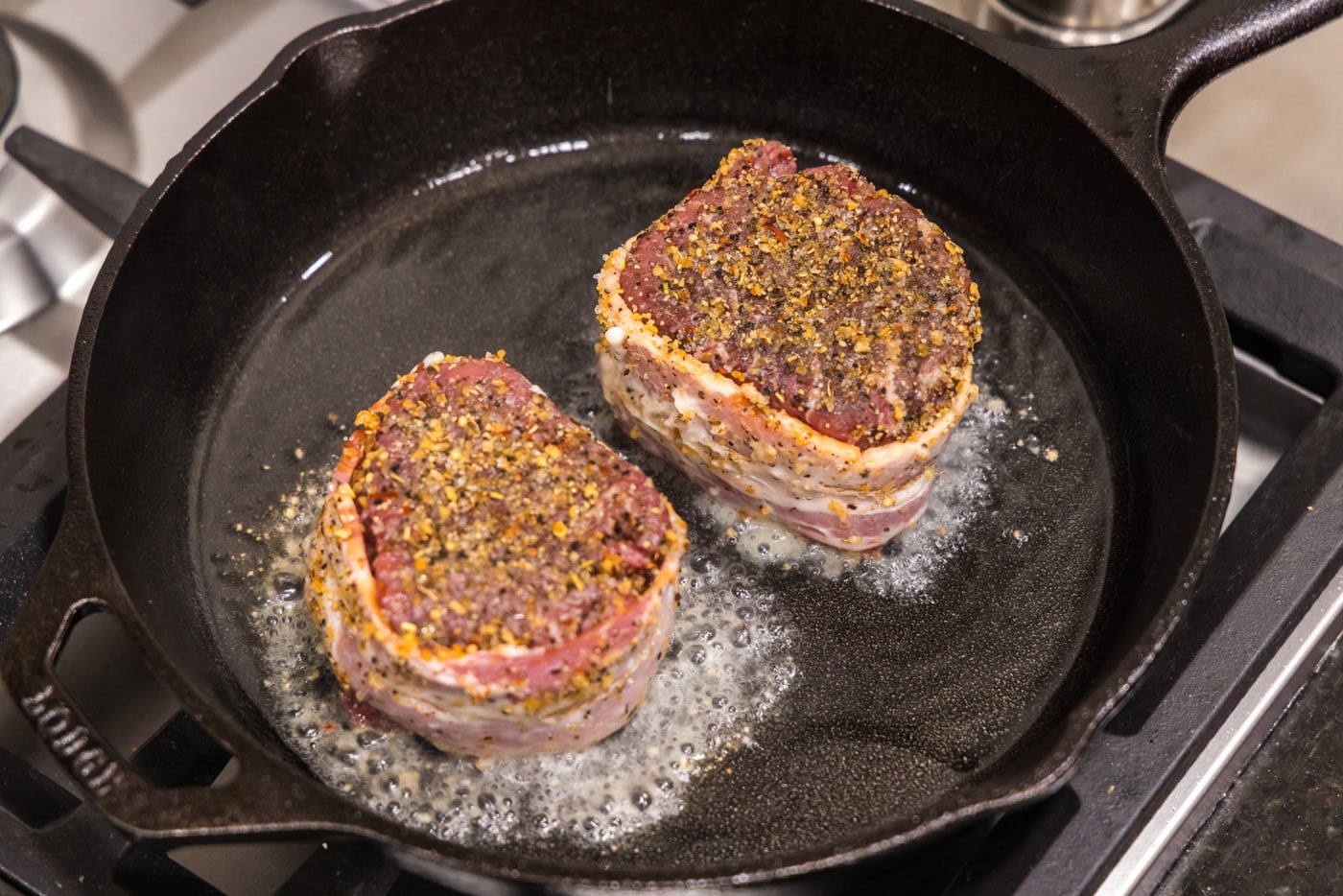 searing filet mignons in a skillet