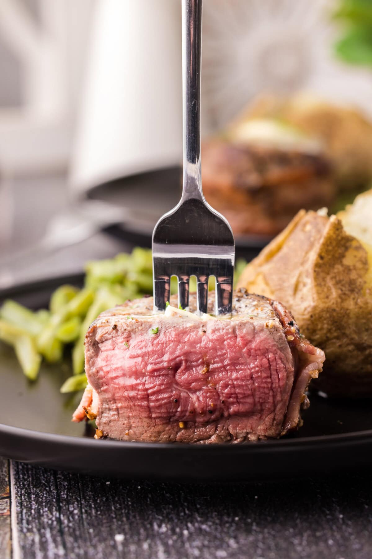 Close up of a fork in a Bacon Wrapped Filet Mignon