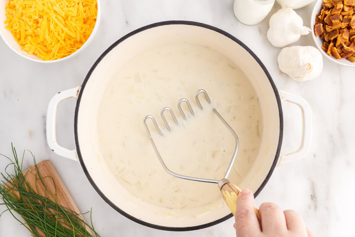 using a mashed to break up chunks of potato in soup