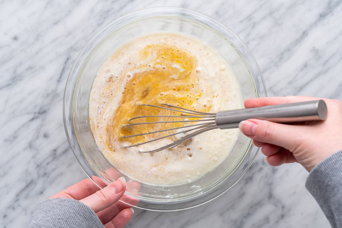 whisking muffin ingredients in a bowl