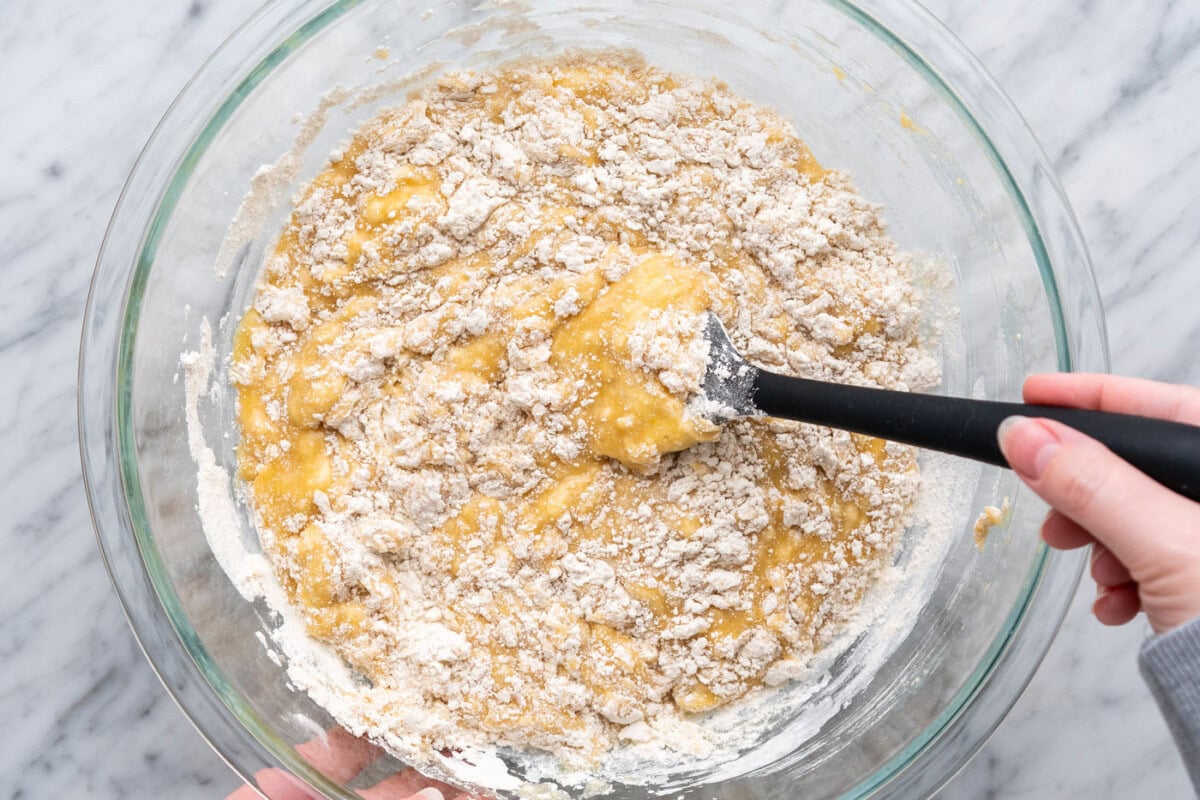 folding and incorporating muffin batter together in a bowl