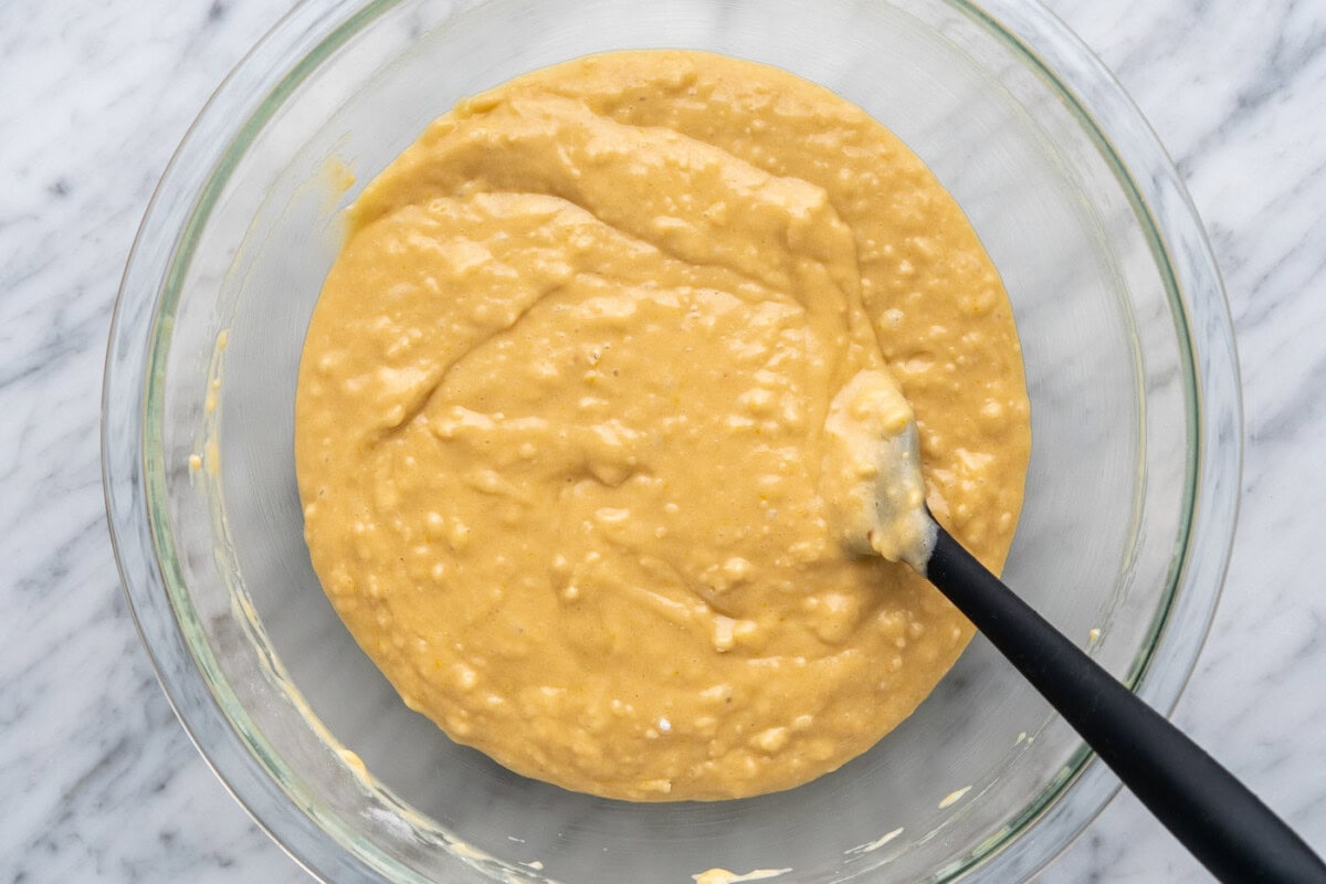 muffin batter in a bowl with a rubber spatula