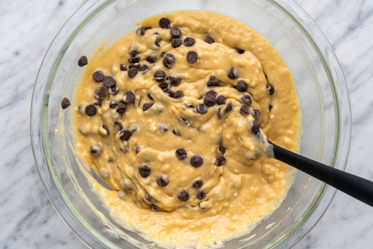 mixing chocolate chips into muffin batter
