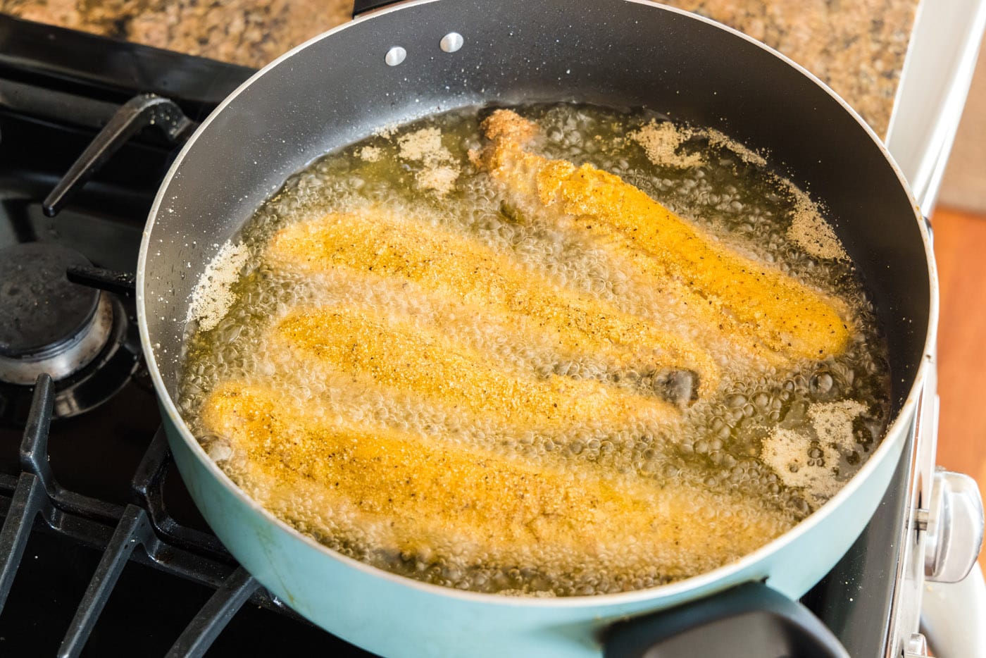 whiting fish frying in oil