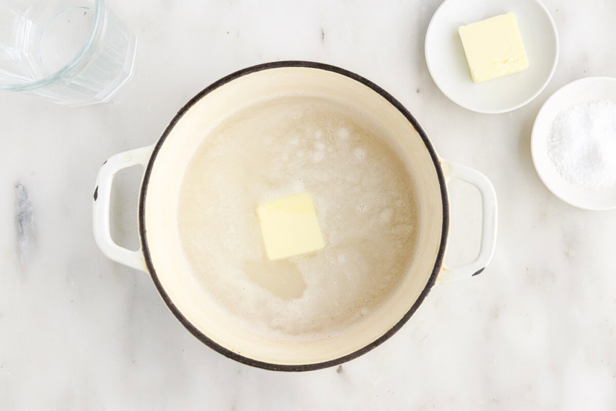 butter added to rice and water in a saucepan