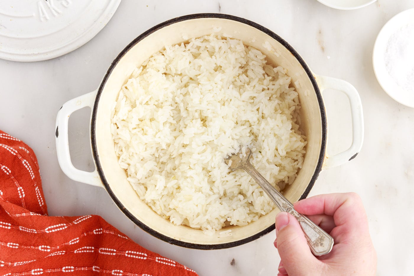 fluffing white rice with a fork