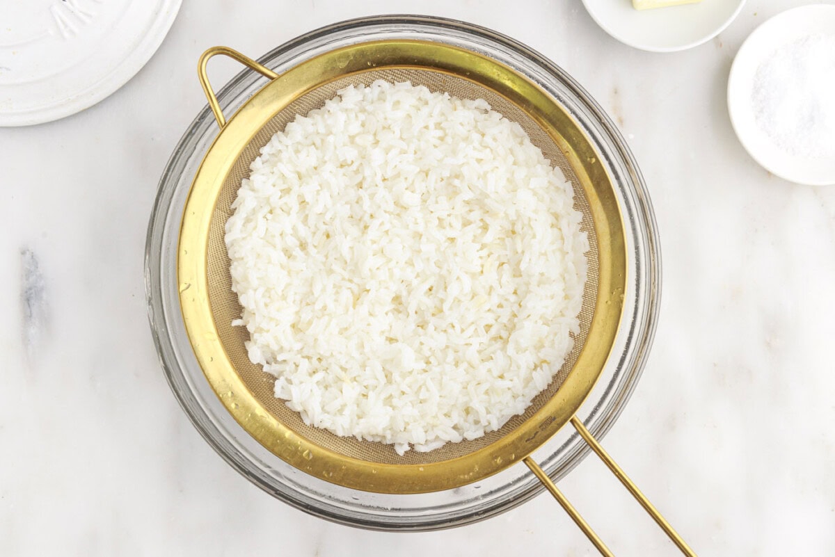 rice draining in a sieve