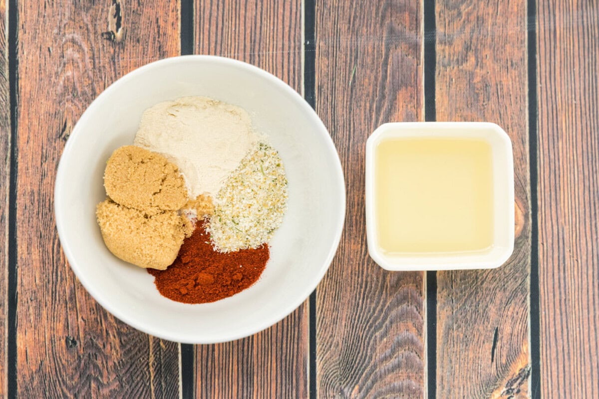 seasonings in a bowl next to olive oil