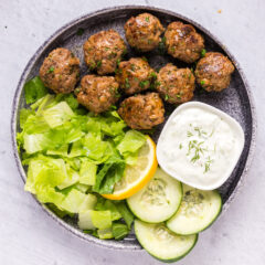 Lamb Meatballs on a plate with tzatziki and lettuce
