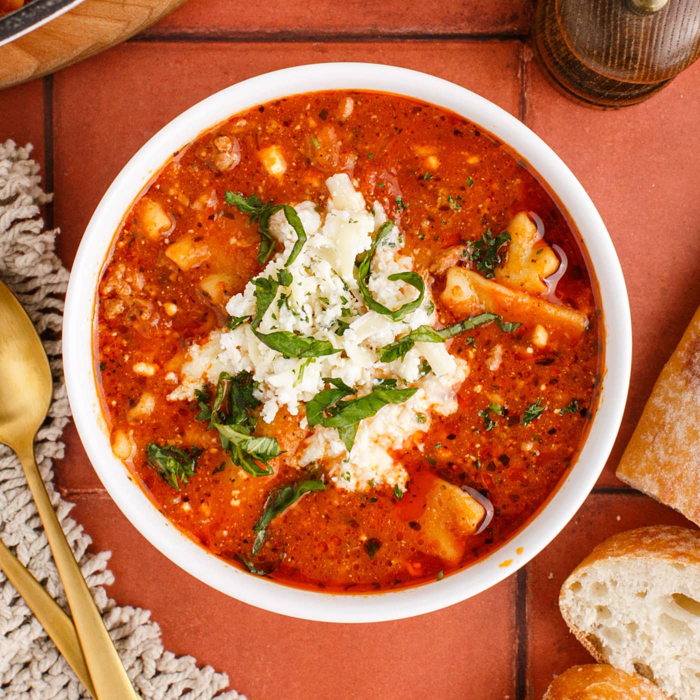 Bowl of Lasagna Soup  topped with cheese mixture and parsley