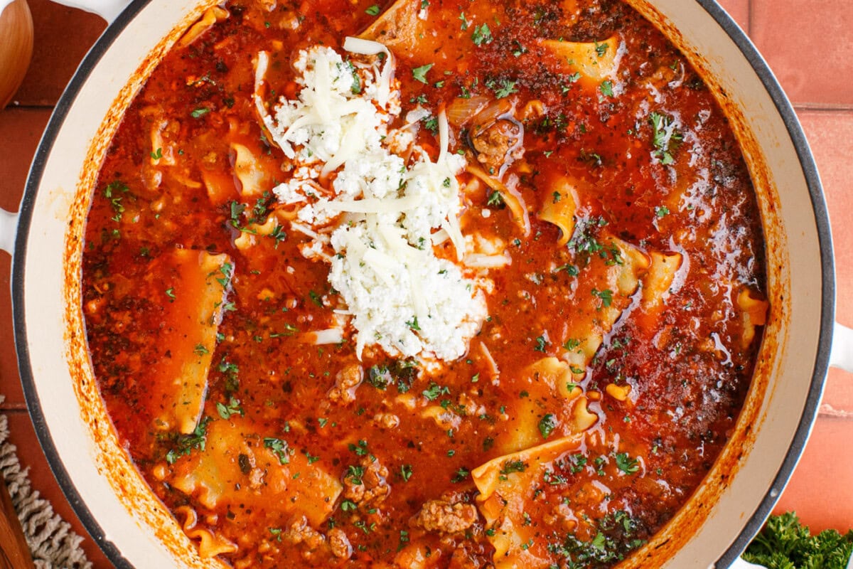 lasagna soup in a pot with three cheese mixture