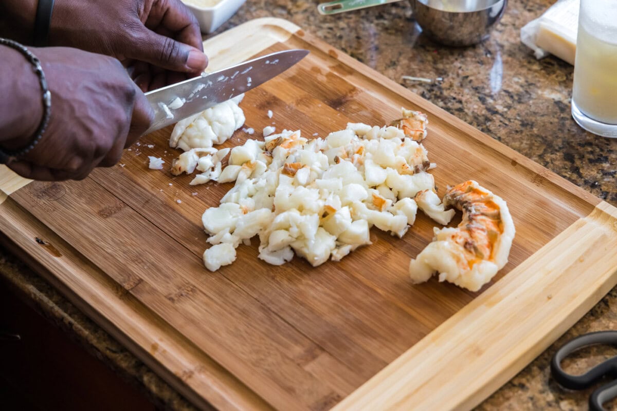 chopping cooked lobster meat with a knife