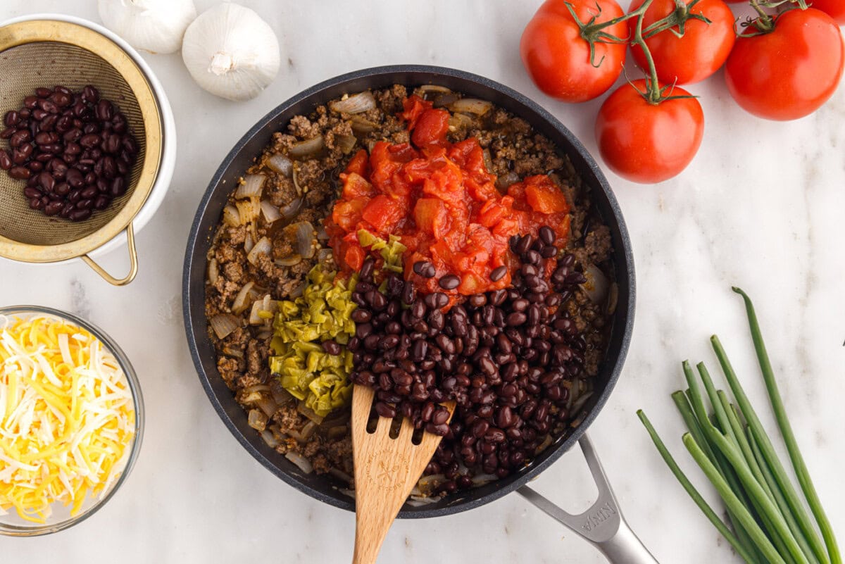 black beans, green chiles, and tomatoes added to ground beef mixture