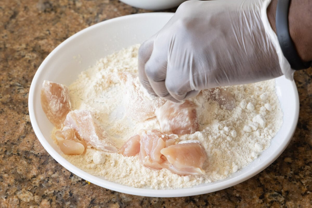 dipping chicken pieces in flour