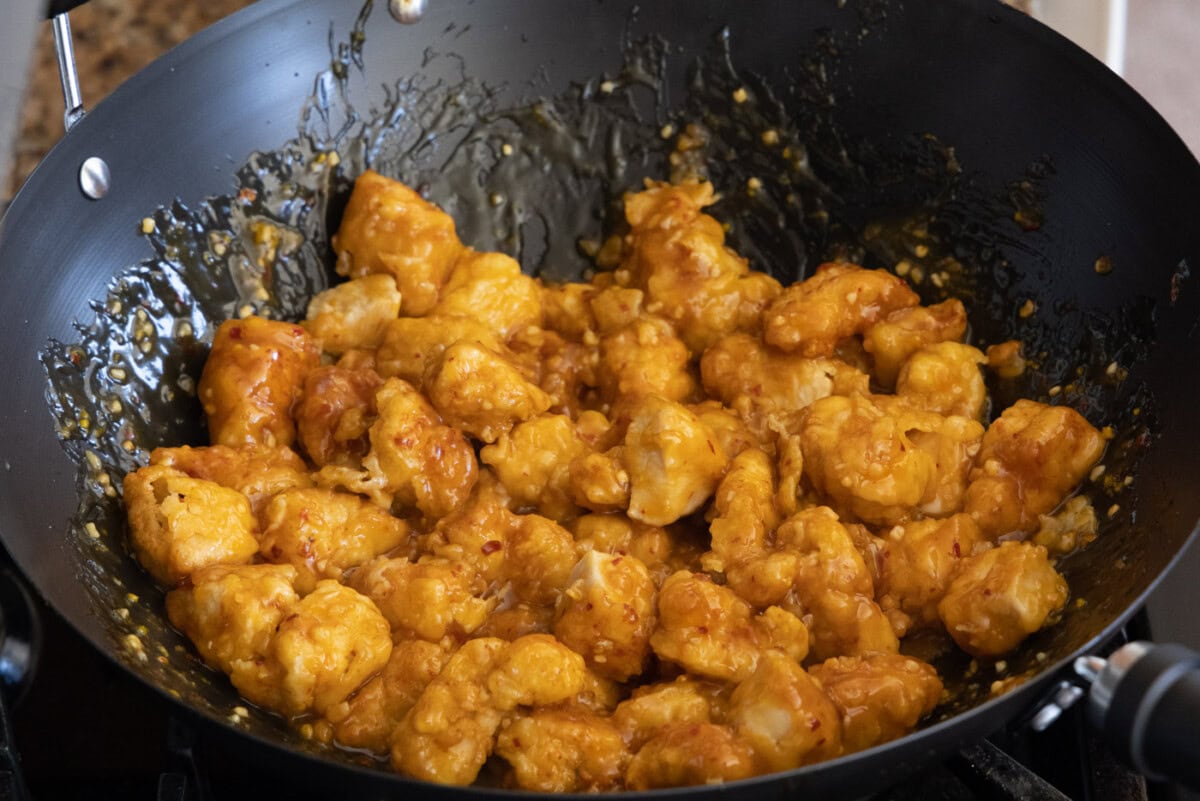 orange chicken pieces in a wok