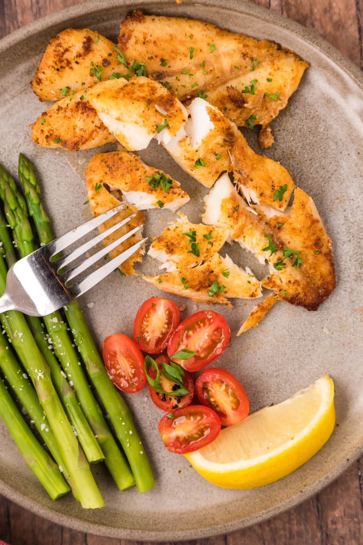 Orange Roughy broken apart on a plate with a fork