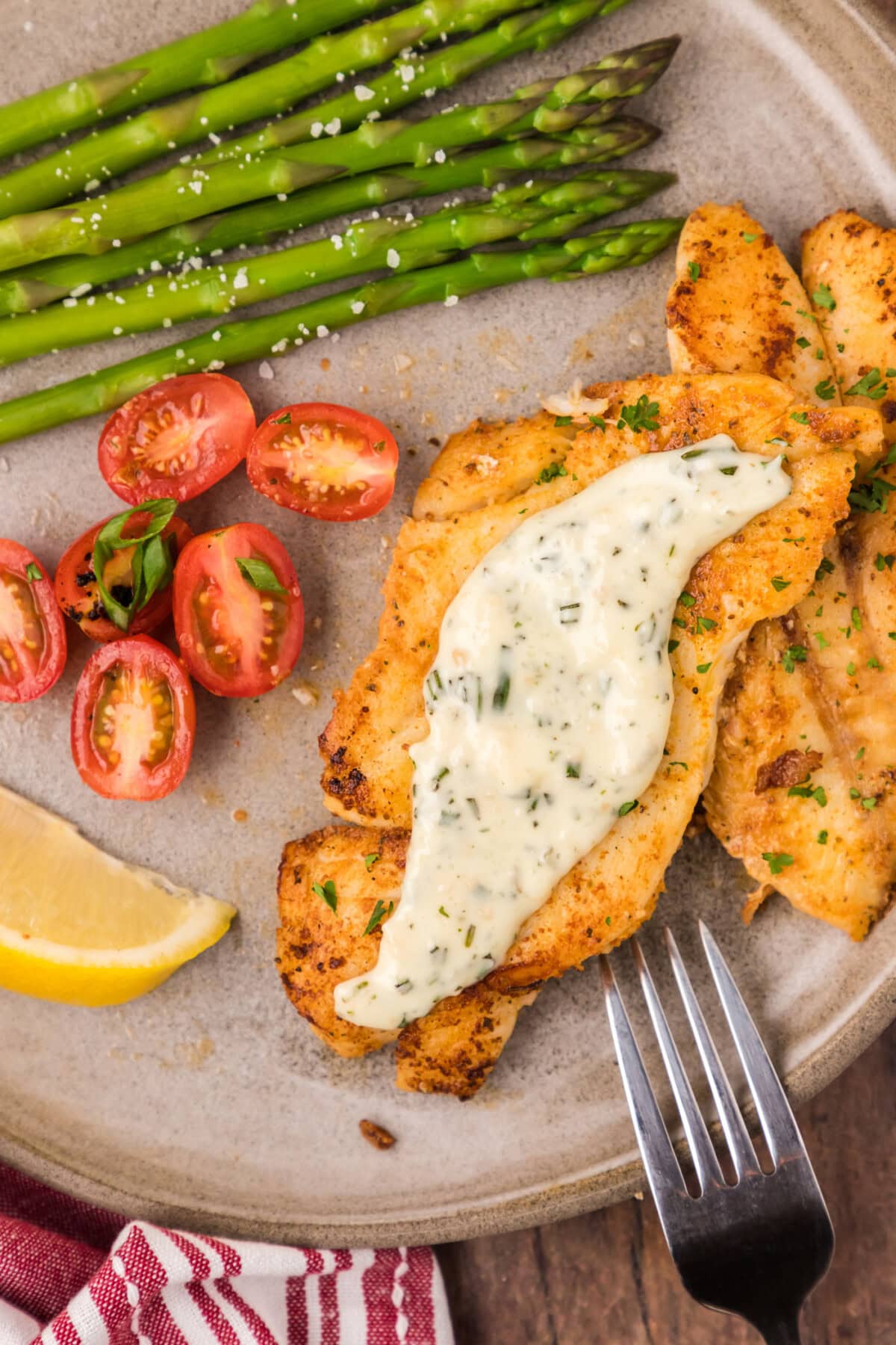 Orange Roughy on a plate topped with rosemary cream sauce