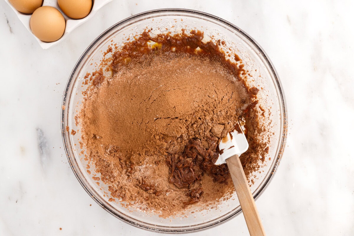 rubber spatula combining dry ingredients and wet ingredients for brownies