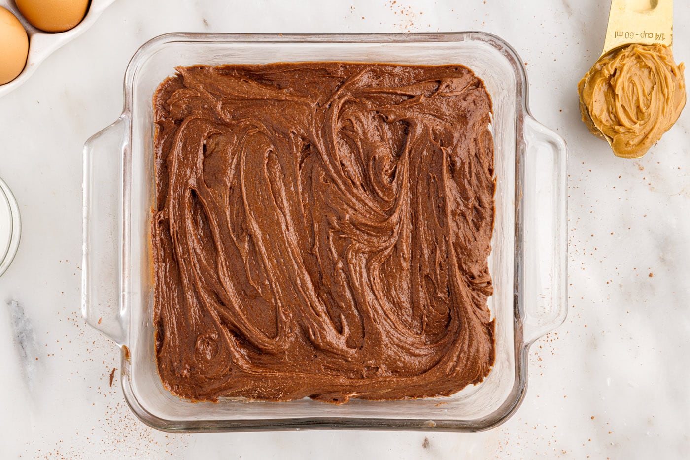 brownie batter in a square baking dish