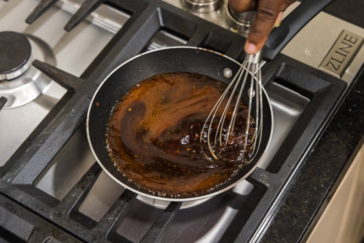 whisking salmon sauce in a skillet