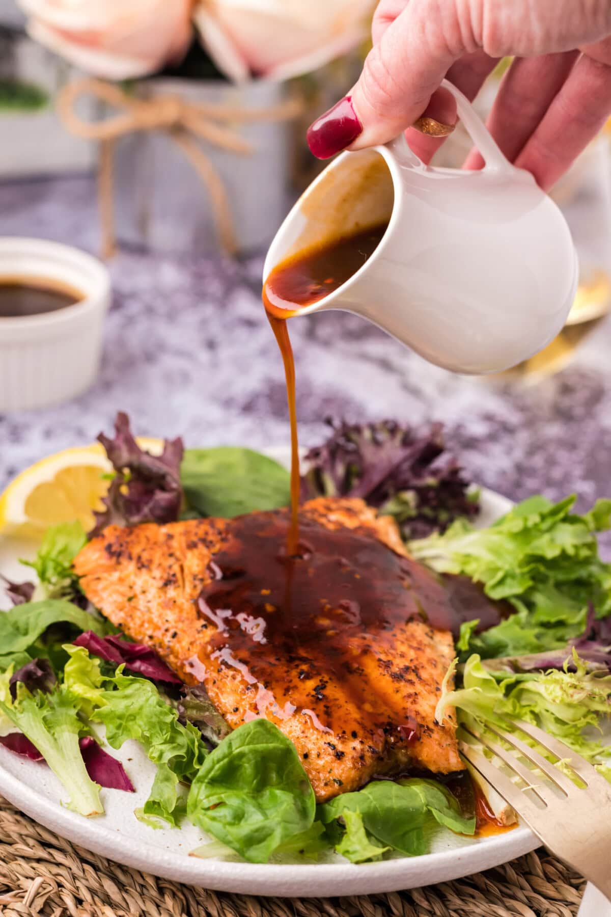 Salmon Sauce being drizzled on a piece of salmon