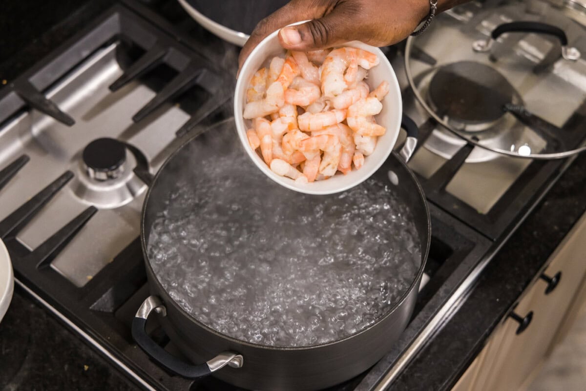 adding shrimp to boiling water