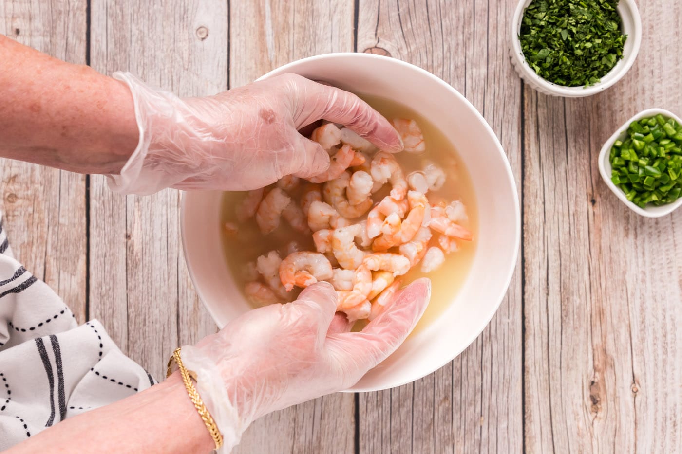 tossing shrimp in lemon and lime juices