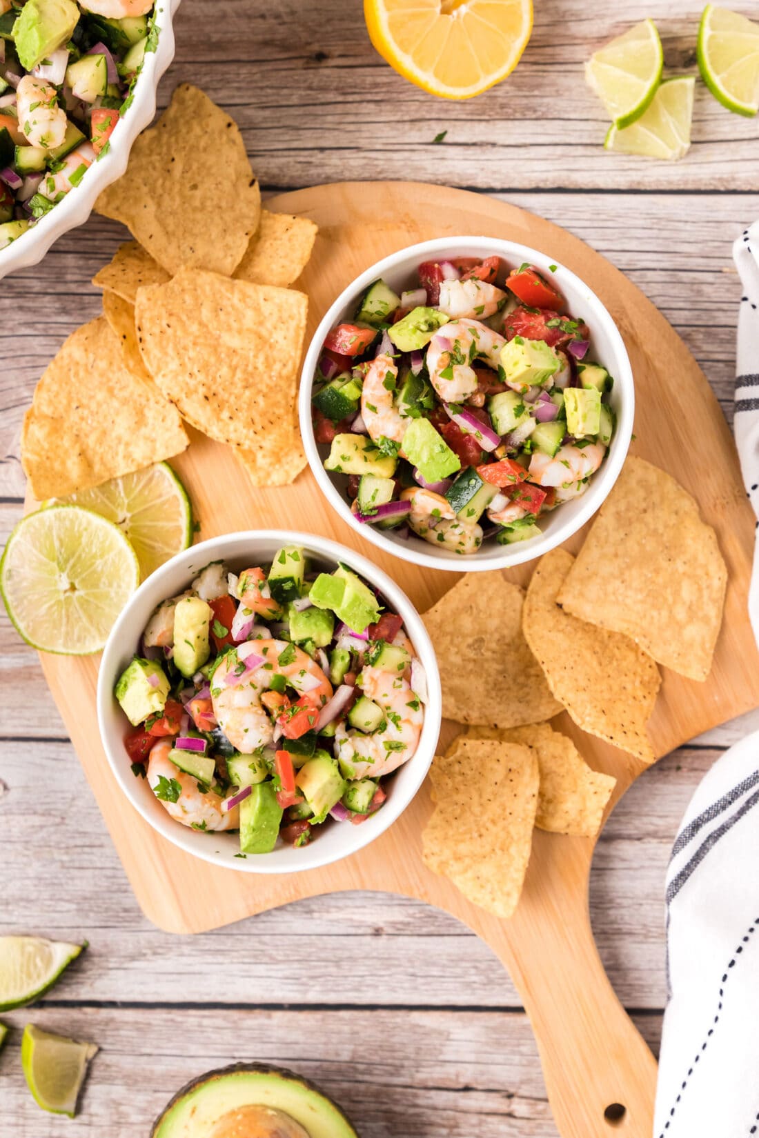 Two bowls of Shrimp Ceviche on a platter with tortilla chips