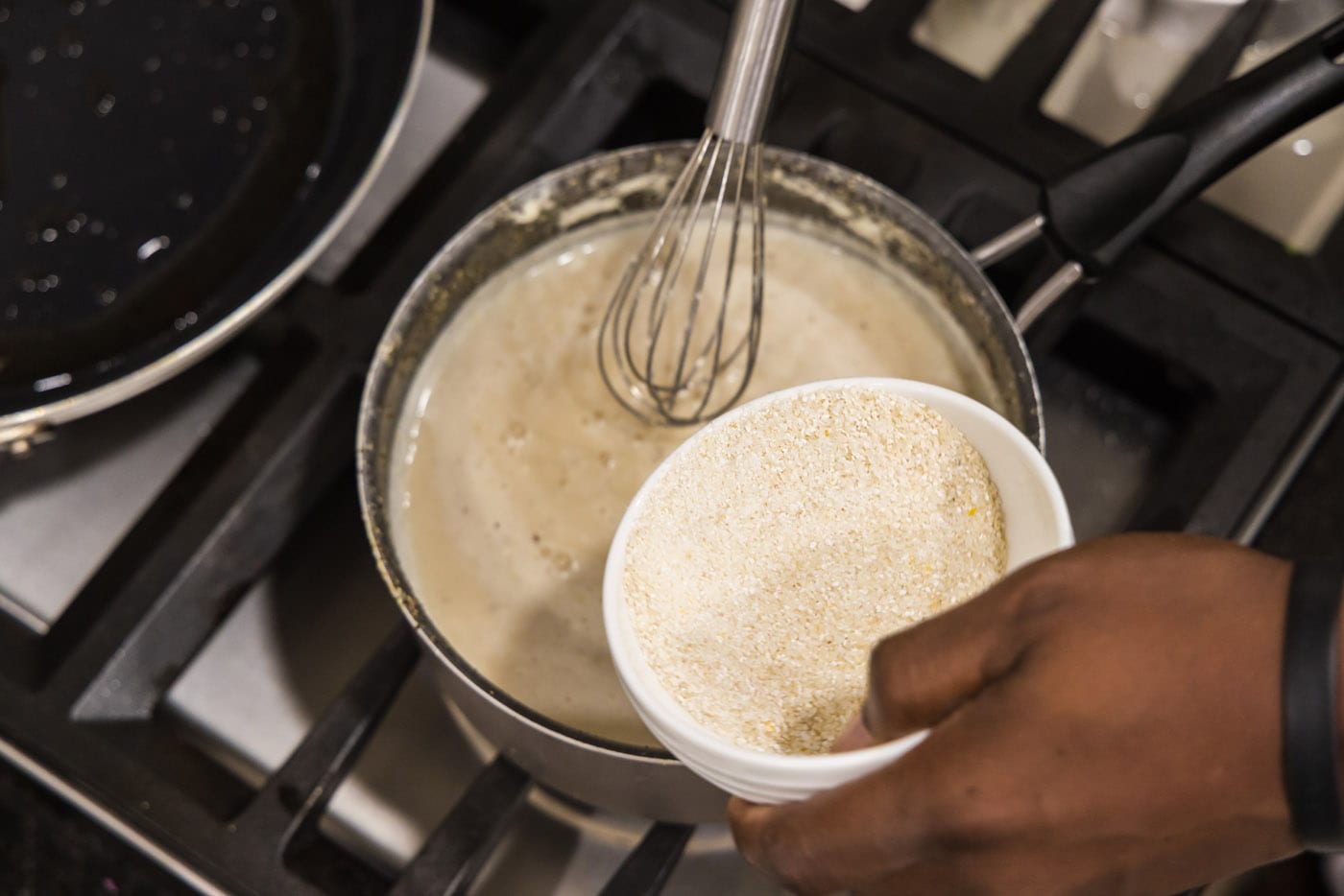 whisking grits into sauce